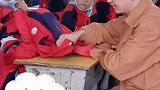 课间老师和学生互动，老师掀起学生的红盖头
