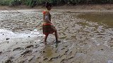 美女荒野泥塘捡螺，看见到鱼螺也不要了，全力捕抓大鱼！