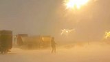 冰岛一名风暴追逐者站在户外体验飓风暴雪 被吹的站不稳
