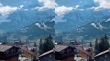 瑞士阿尔卑斯山，山上积雪不化山下绿草如茵，还有星罗棋布的木屋