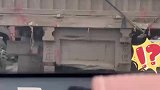 红灯时男子下车，好心将前车被遮挡的车牌擦净