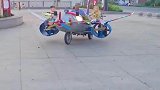 大爷开着三轮飞机遛娃，还随车播放爱国歌曲