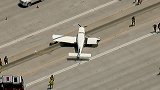 美国：一架小型飞机迫降高速公路，骑在了隔离栏上