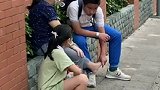 广东广州：学校门口妈妈不慎崴脚，孩子坐路边帮其细心按揉