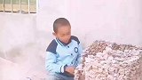 小男孩自己用石子搭建城堡