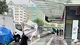 台风天男子撑伞上街，谁料风太大竟被吹走帽子