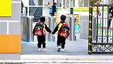 两个小萌娃牵手走进幼儿园，保安大叔看到后又蹦又跳迎接