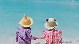 两个萌娃牵着手去海边，真的好可爱啊