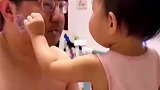女儿在爸爸脸上贴贴纸，为了让贴纸牢点上手就来了一巴掌！