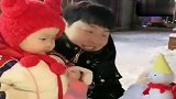 爸爸给暖宝堆了一个小雪人，暖宝看到后嫌弃它太小了