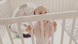 小宝宝睡醒后乖乖站在床边等妈妈，看到妈妈后笑得眼睛像月亮！