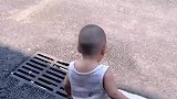萌娃光脚在柏油路上被烫到踮脚