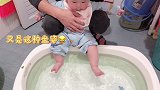宝贝洗澡前总要先戏一下水，瞧那捣腾的小脚丫，裤子都给弄湿了