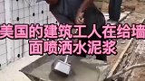 米国工人给墙面喷洒水泥浆