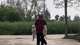 奶奶拎着两只贪玩的猫咪回家，像极了两个犯错的小朋友
