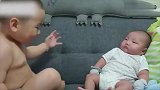 小哥哥想要抱起二胎妹妹，还得再练练哦！