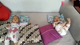 双胞胎宝宝一起躺在床上，奶奶开心的逗两个小宝贝