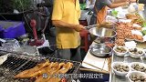 大叔街边用炭火烤鱿鱼，小刀划上几刀，蘸上酱汁，光看颜色就馋了