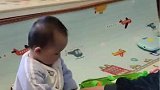 爸爸正在带娃，萌娃拿娃娃就非要拿走逗他