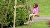 恶作剧：小女孩荡秋千，一脚把途经的车手踹下水