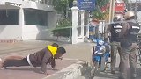 泰国街头少年违规骑摩托被拦 没钱交罚款竟做起俯卧撑