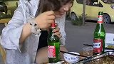 情侣外出吃烧烤，女友帮男子开酒瓶