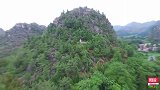 航拍贵州山区，一座孤山上发现一坟墓，山顶塑有围墙！
