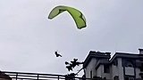 男子驾滑翔伞突然失控撞向楼顶，市民拍下惊险一幕