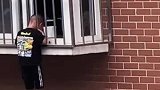 小孩头卡防盗窗，身体悬5楼窗外，男子徒手爬楼托举救娃