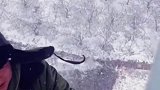 工人冒着风雪爬上高空线塔作业