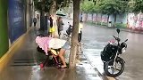 因为没有地方避雨，一位妈妈用自己身躯为孩子挡雨，母爱伟大！