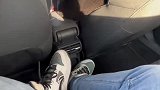 男子坐在汽车后座，结果位置太小裤子都撑破了