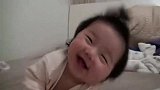 睡觉的小萌娃,突然醒来笑了起来