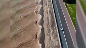 钱塘江杭州段重现“神龙摆尾”：浪花层层叠叠追着路人跑