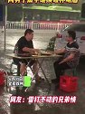 四川宜宾：突降暴雨，两男子雨中继续碰杯喝酒