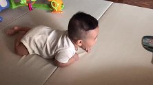 小宝宝趴在床上玩，一脸落寞的表情，真是叫人喜欢啊！