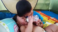 霸道的小哥哥怼着奶瓶给弟弟喂奶，宝宝表示快松开憋死我了！