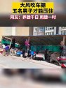 北京：一车棚被大风吹翻，五名男子站上木桩才能压住