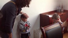收养的中国男孩眼含泪花贴墙而站，紧张害怕的模样让人心疼