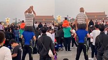 老父亲坐儿子肩头看天安门升旗 激动地不停鼓掌